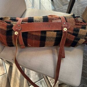 Pendleton Plaid motor robe in Black, Orange, and Tan leather carrier